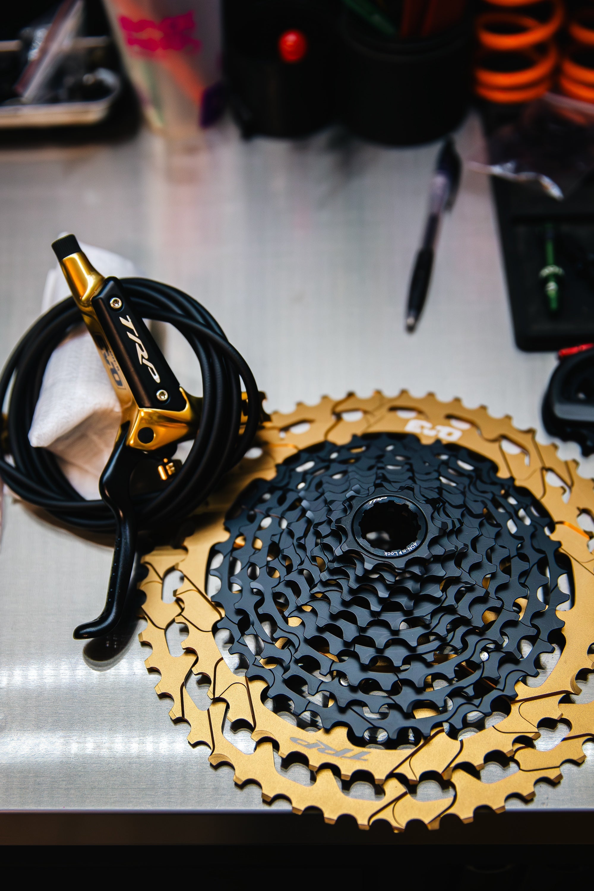 close-up of MTB TRP lever and cassette in gold