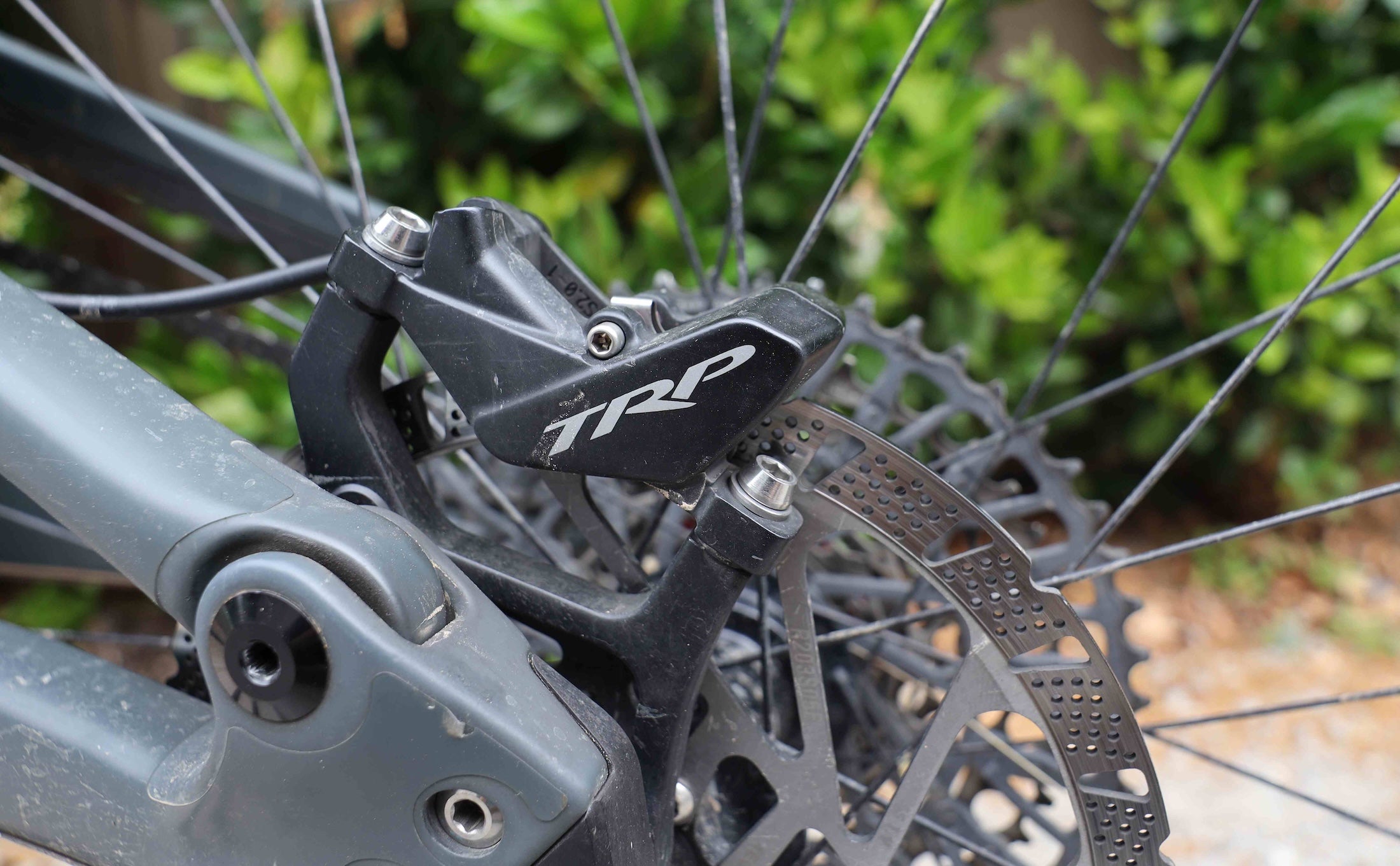 TRP EVO Pro brake rear caliper and disc in close up mounted on a mountain bike