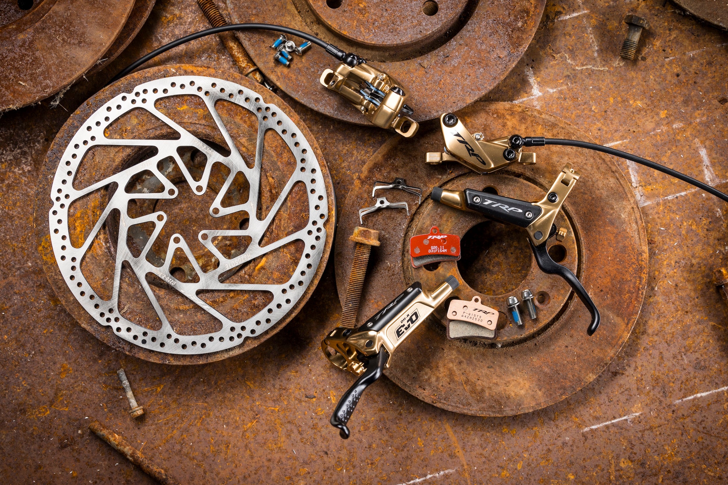 TRP Bicycle brake components on a rusty metal surface