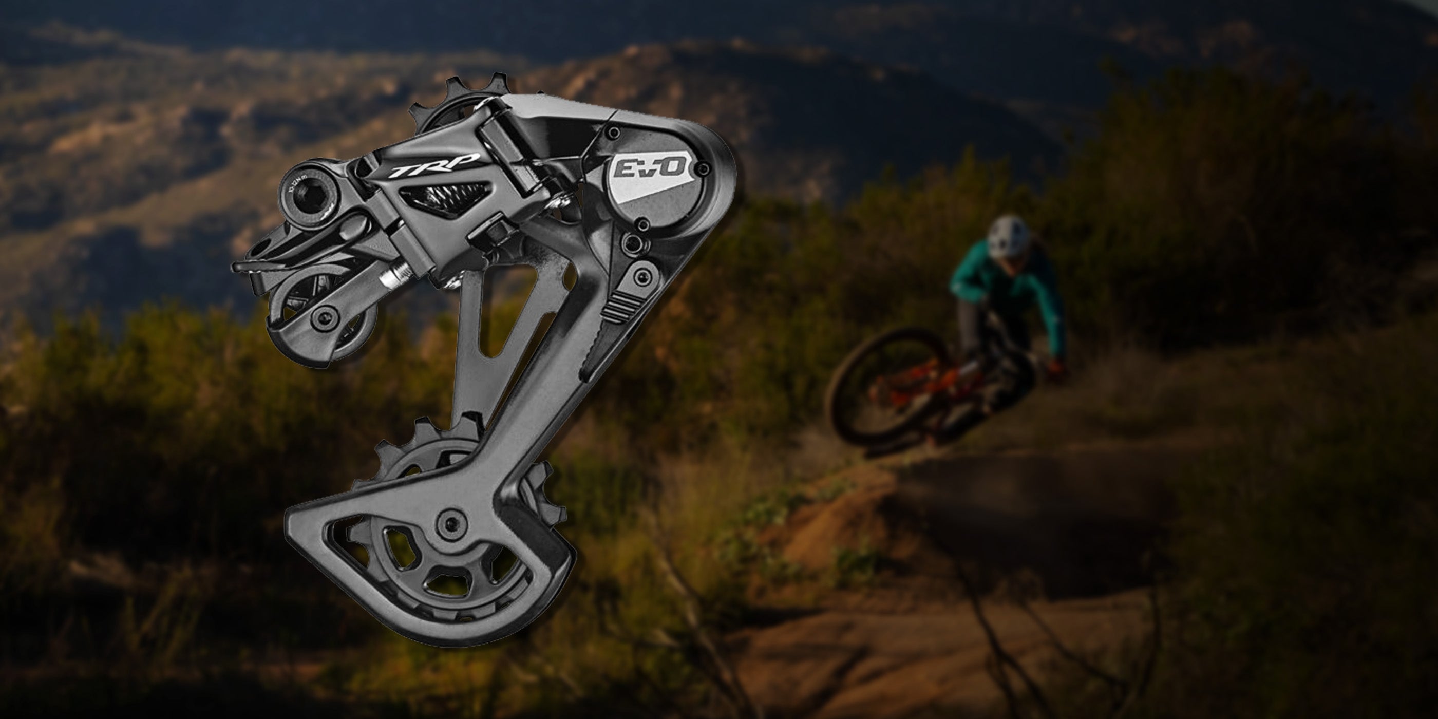 Shows TRP EVO mountain bike derailleur cage release mechanism for quick wheel changes during trail maintenance