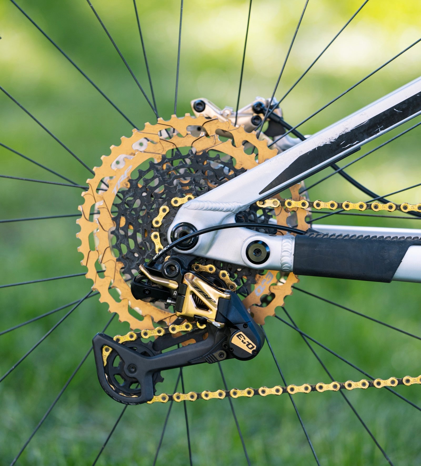 Close-up of TRP derailleur and cassette in gold mounted on a bicycle