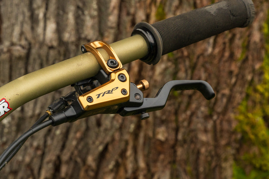 Close up of TRP EVO lever in gold mounted on handlebar
