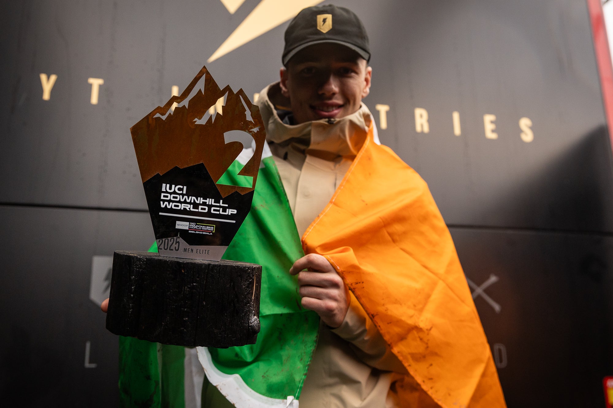 TRP Team rider holding a trophy with an Irish flag draped over them, in Poland