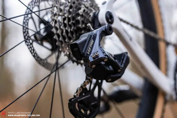Close-up of a bicycle gear system with a brand logo.