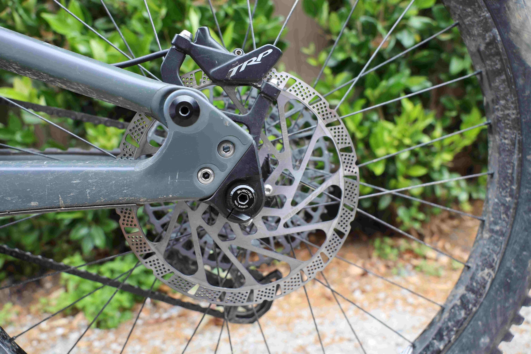 TRP EVO Pro brake rear caliper and disc in close up mounted on a mountain bike