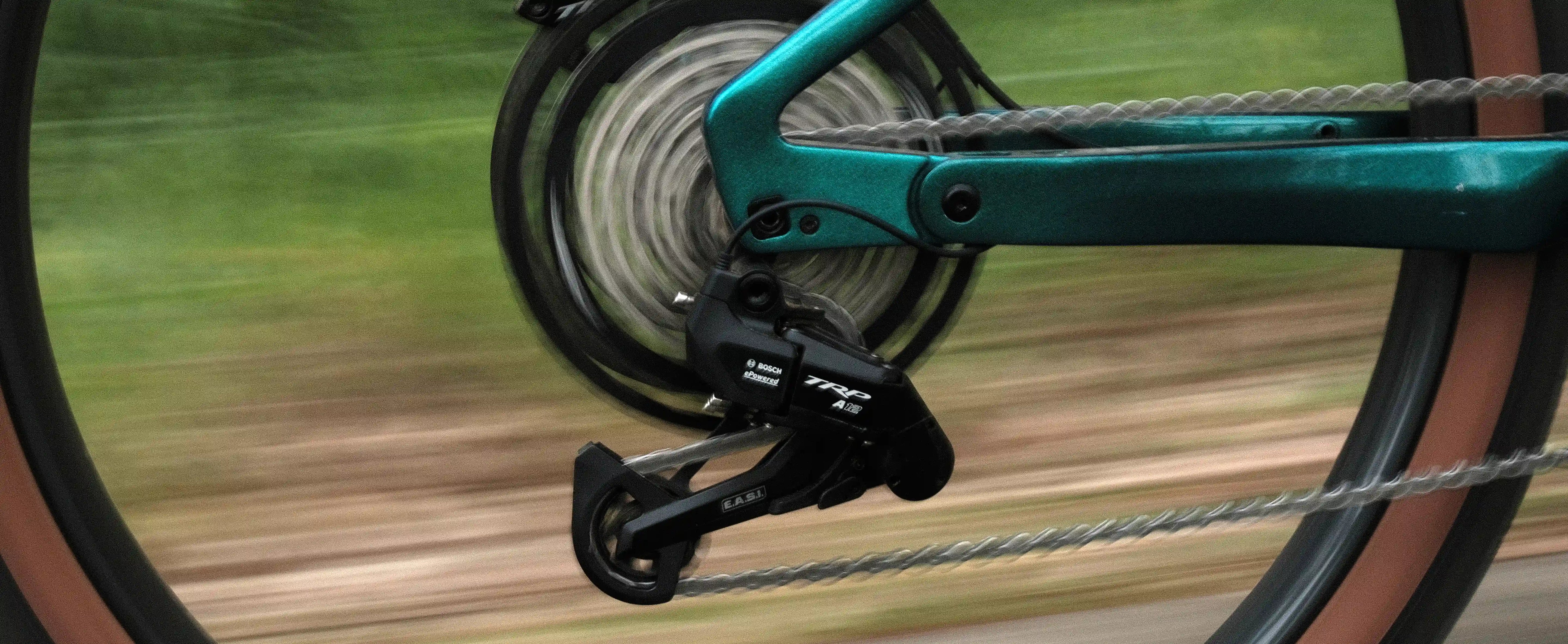 Close-up of a bicycle with TRP E.A.S.I chain and gear system with a blurred background